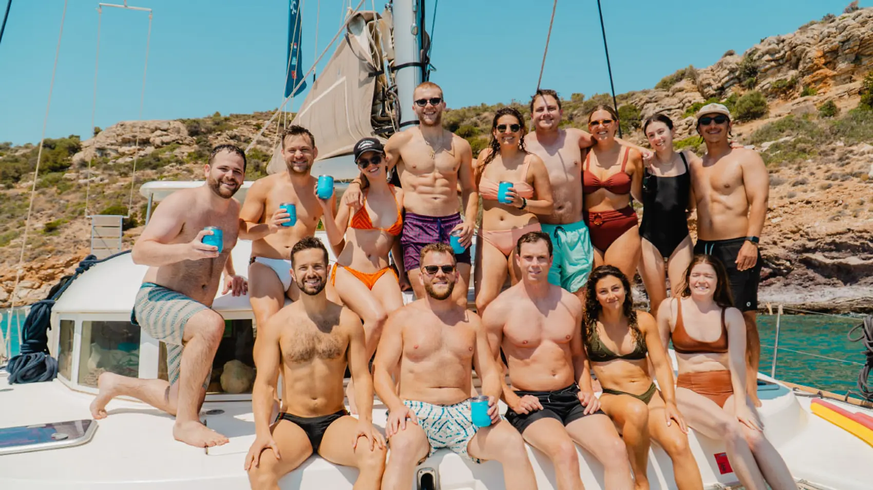 Group of guests pose for a photo on a yacht