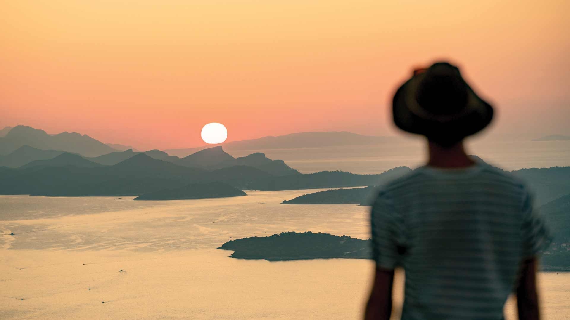 Man looking at the sunset over Croatian islands