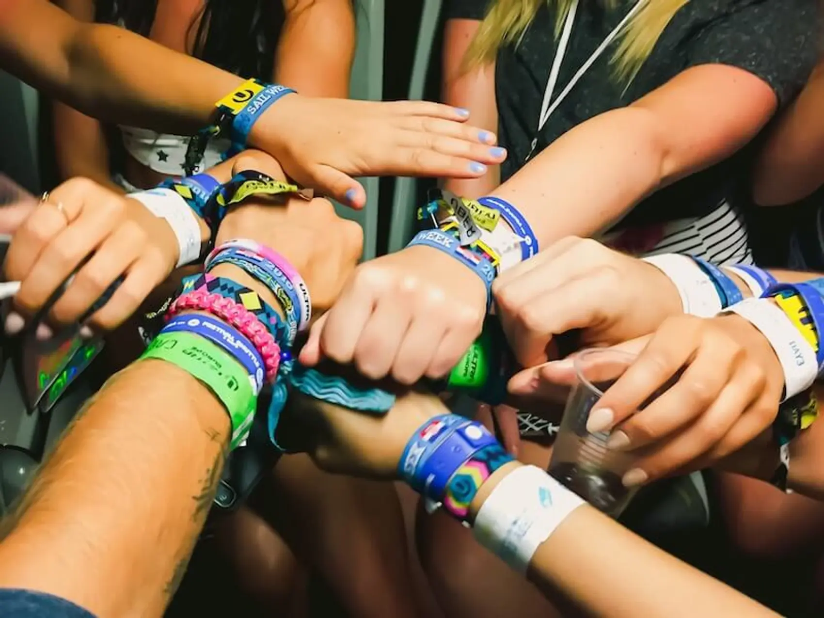 Photo of hands with wrist bands for festivals in Europe.