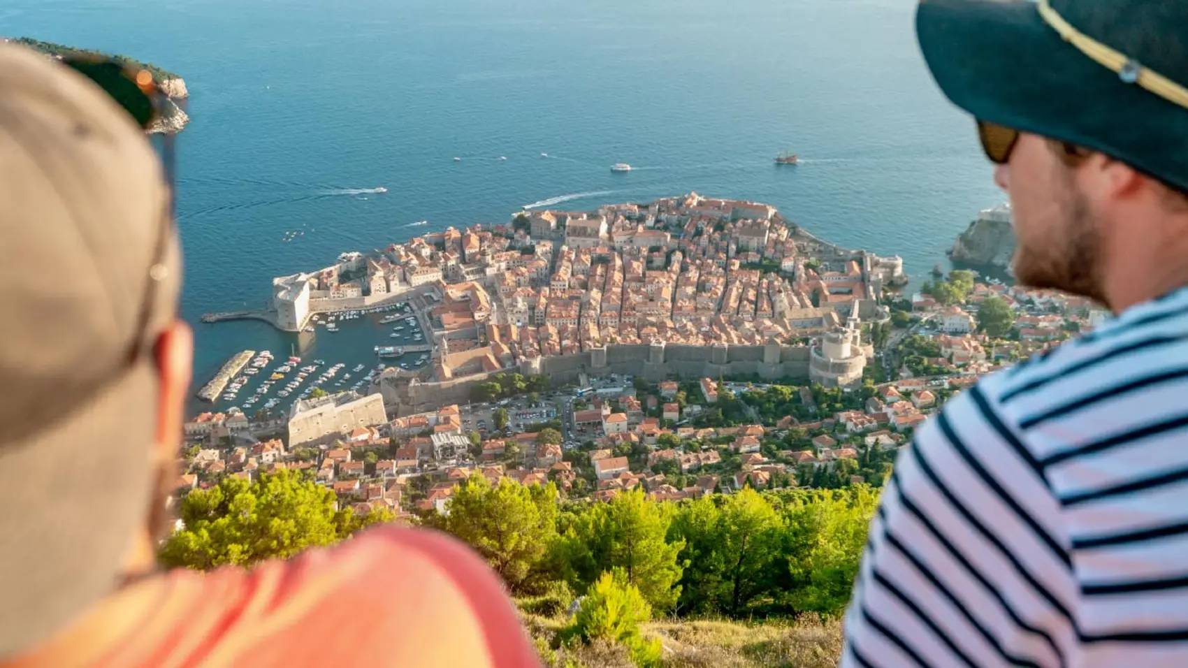 Two people look at the view over Dubrovnik town