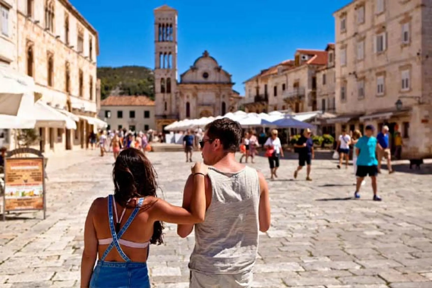 Couple walk through Hvar Old Town in Croatia