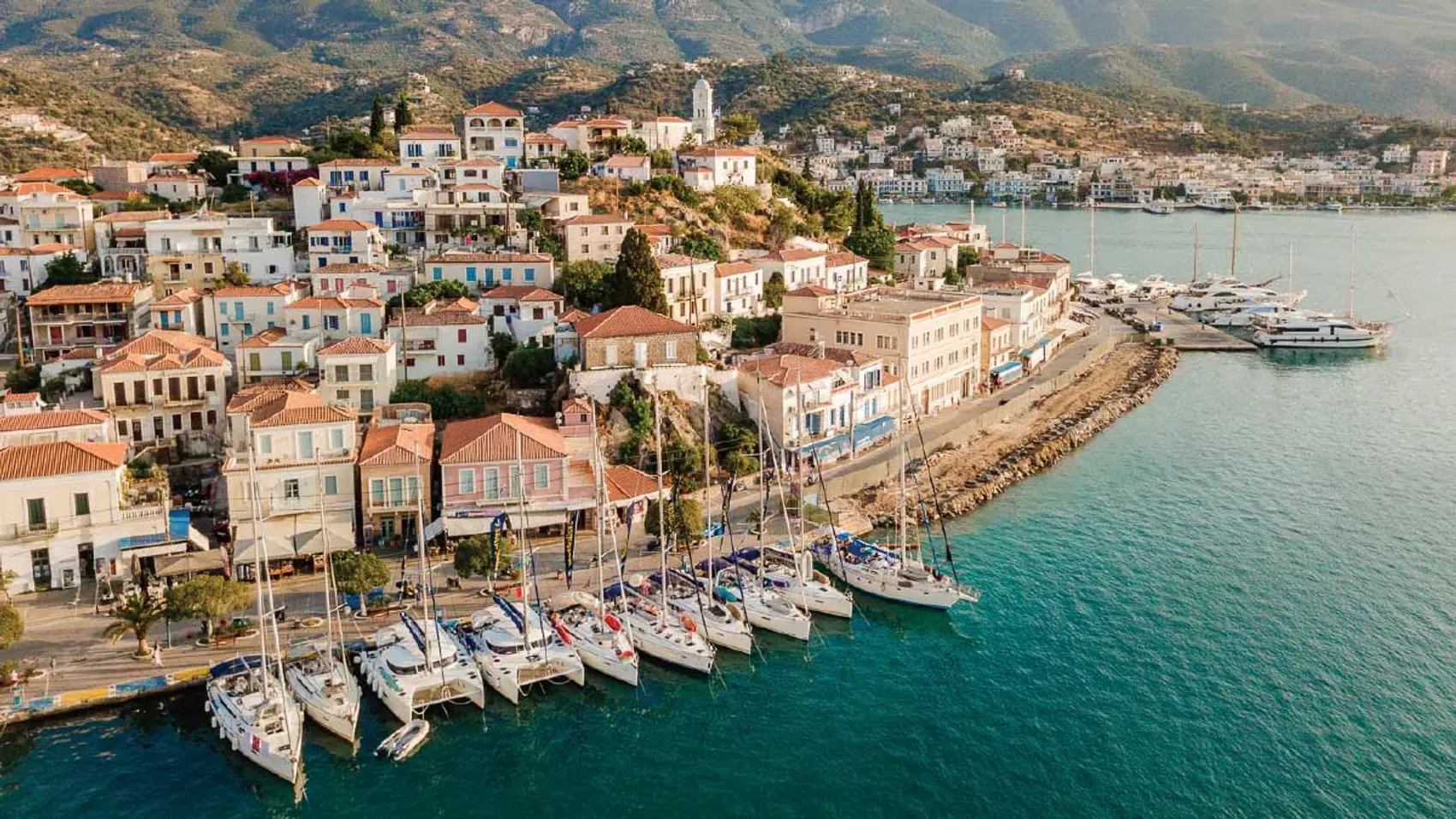 MedSailors yachts lined up on the Poros town quay